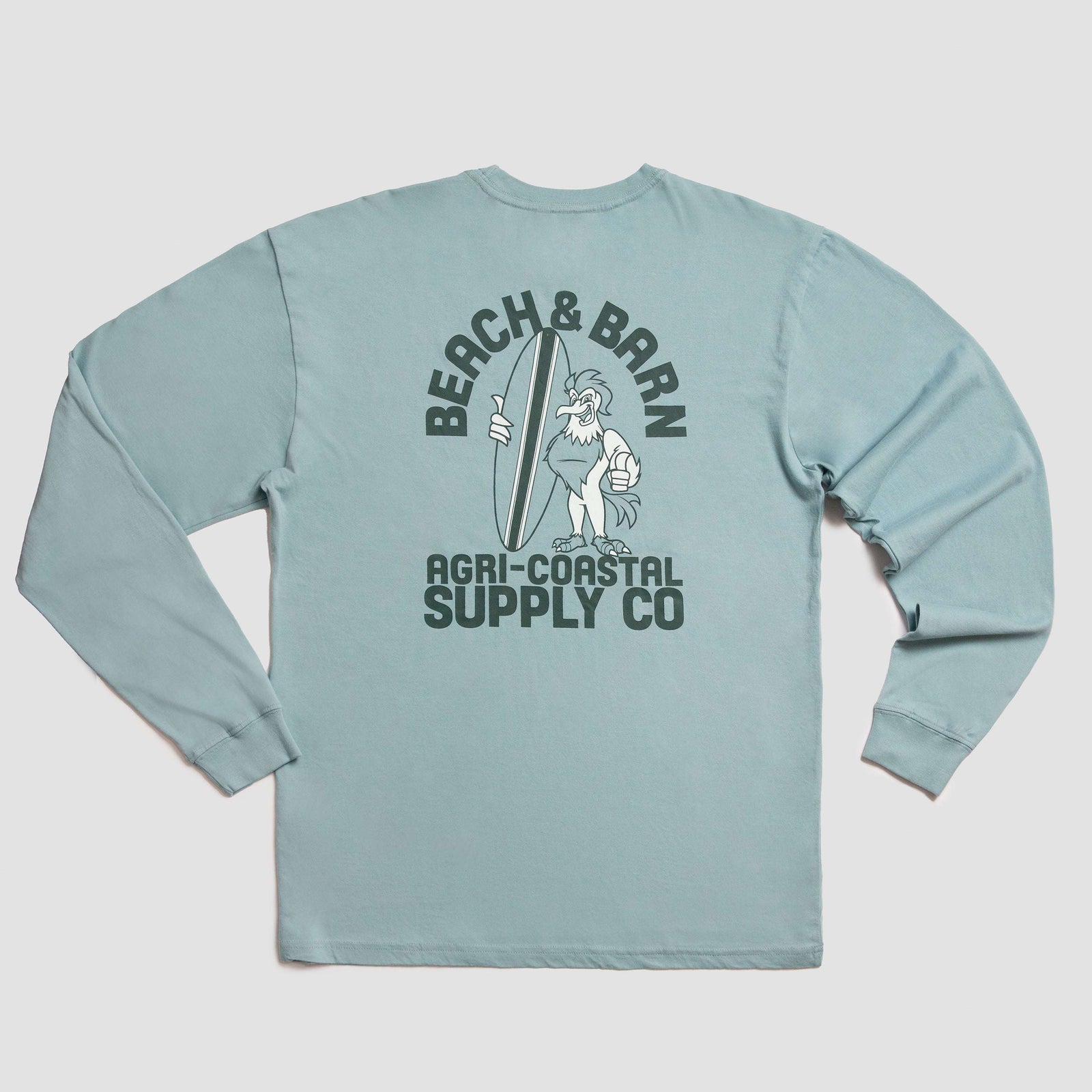 Light blue long-sleeve shirt with a graphic on the back showing a rooster holding a surfboard. Text above and below reads BEACH & BARN and AGRI-COASTAL SUPPLY CO. in dark lettering.